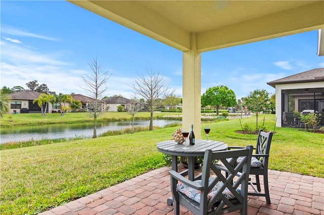 view of patio / terrace with outdoor dining space and a water view