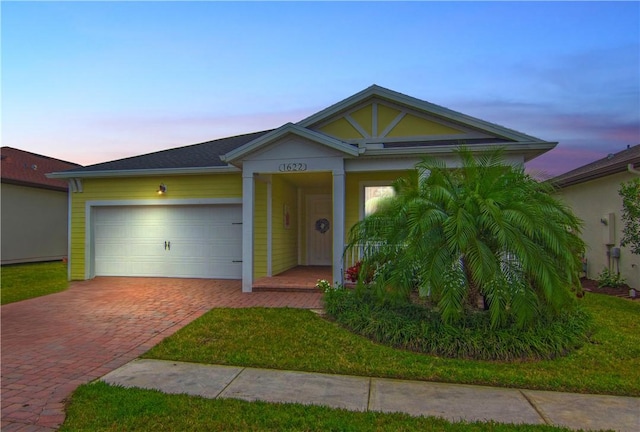 view of front facade featuring a garage and decorative driveway