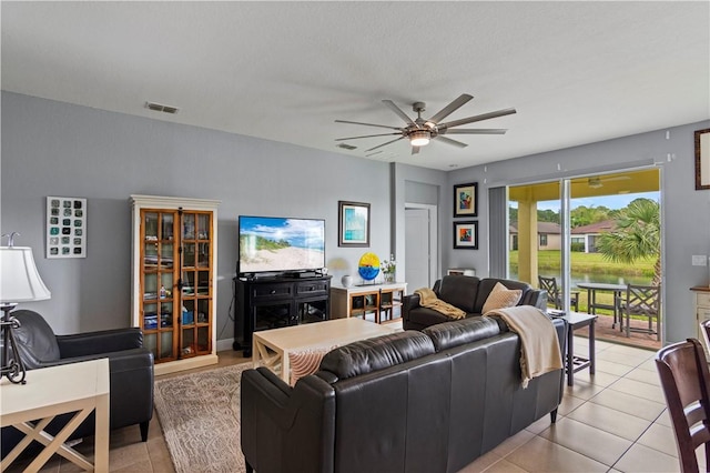 living room with light tile patterned floors, ceiling fan, and visible vents