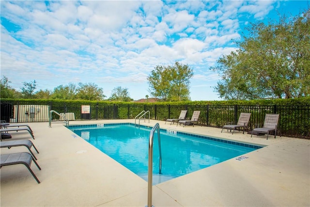 community pool featuring a patio area and fence