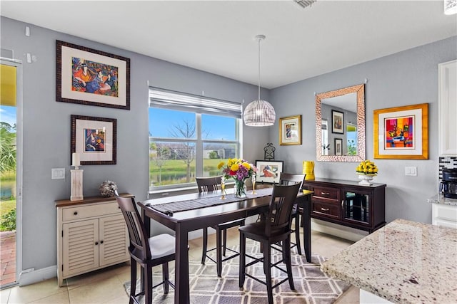 dining area with baseboards and light tile patterned floors