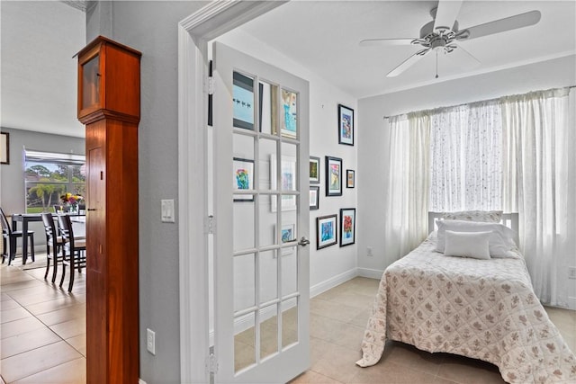 bedroom with light tile patterned floors and baseboards