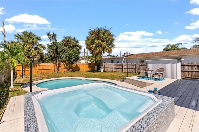 view of swimming pool with an in ground hot tub and a deck