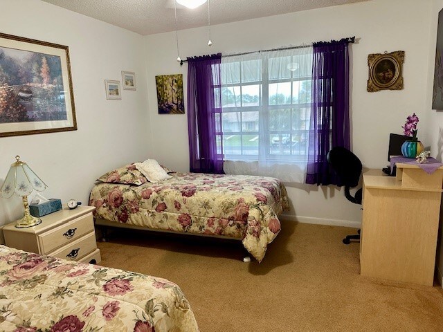 carpeted bedroom featuring a textured ceiling