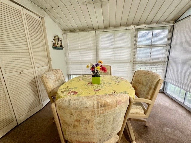 dining area with wood ceiling, lofted ceiling, and carpet floors