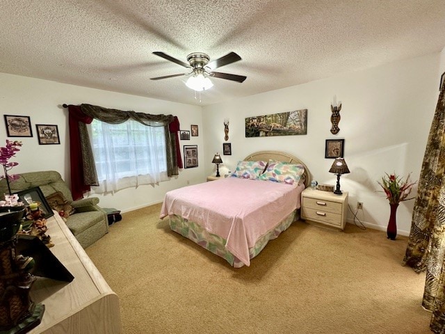 bedroom with ceiling fan, a textured ceiling, and light colored carpet