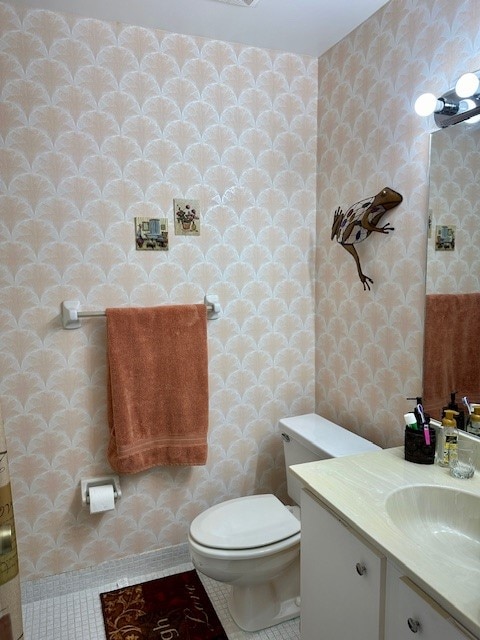 bathroom featuring tile patterned floors, vanity, and toilet