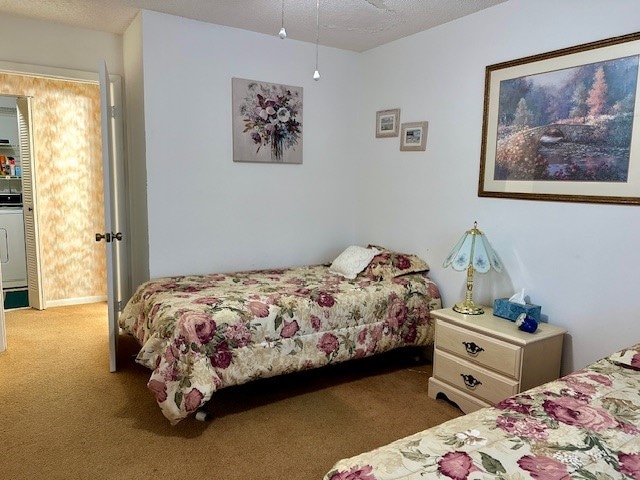 bedroom featuring carpet and a textured ceiling
