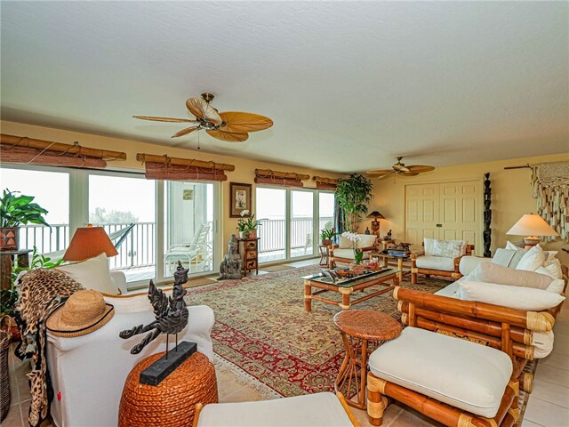 tiled living room with ceiling fan