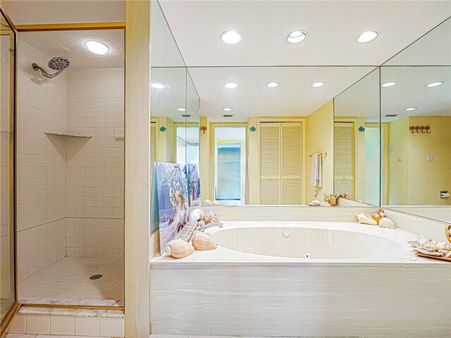 bathroom with separate shower and tub