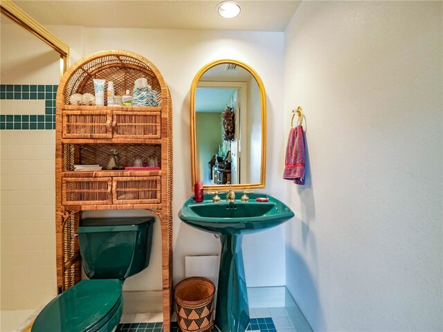 bathroom featuring toilet and tile patterned flooring