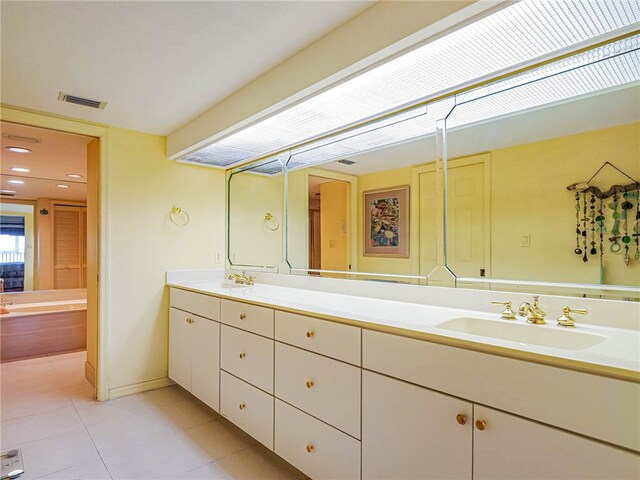 bathroom featuring tile patterned flooring and vanity