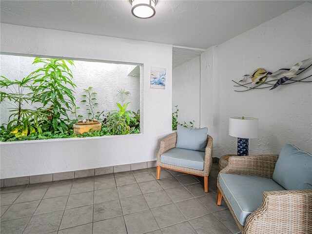 sitting room with tile patterned floors