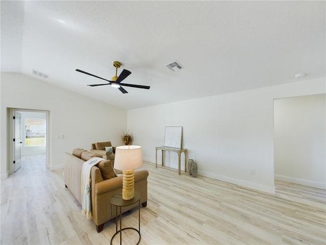 living area featuring ceiling fan, lofted ceiling, and light hardwood / wood-style flooring