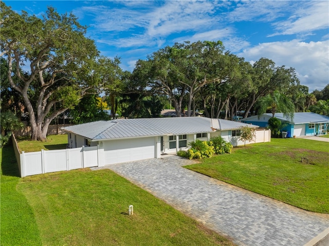 ranch-style house with a garage and a front lawn