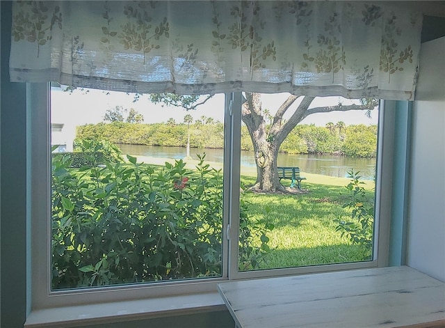 doorway to outside with a water view