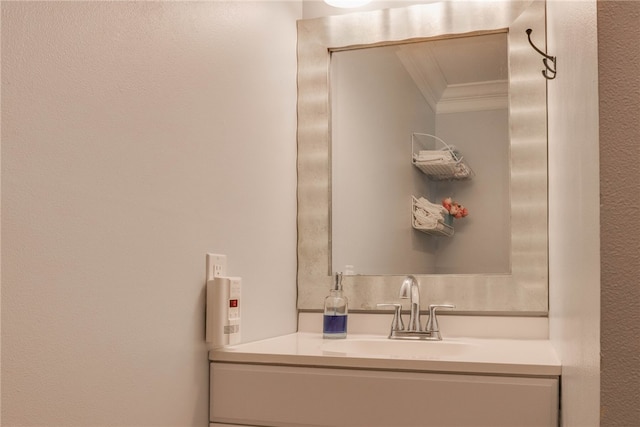 bathroom with vanity and crown molding