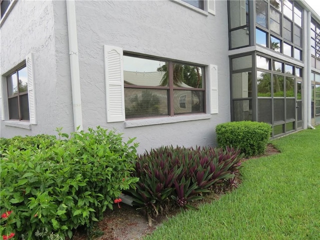 1801 Indian River Blvd Unit C1, Vero Beach, FL 32960 - view of home's exterior featuring stucco siding and a yard