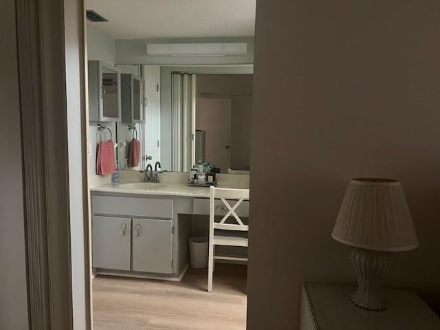 1801 Indian River Blvd Unit C1, Vero Beach, FL 32960 - bathroom featuring wood finished floors and vanity