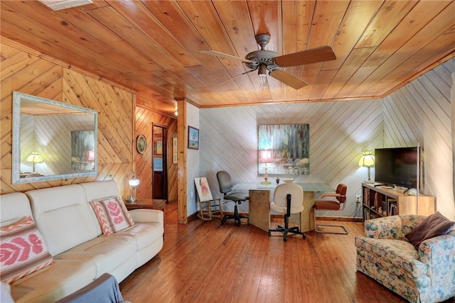 living room with a ceiling fan, wood ceiling, and wood finished floors