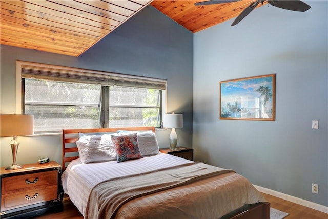 bedroom featuring baseboards, wooden ceiling, ceiling fan, wood finished floors, and vaulted ceiling