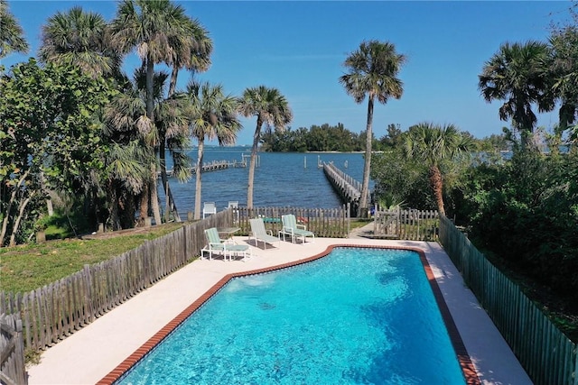 view of swimming pool with a water view, a patio area, a fenced backyard, and a fenced in pool