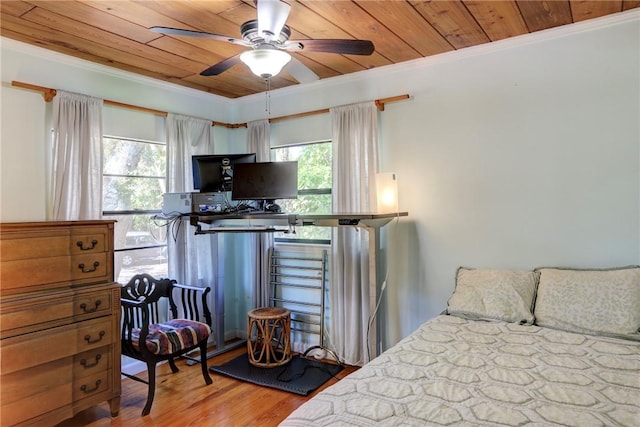 bedroom featuring wooden ceiling, ornamental molding, and wood finished floors