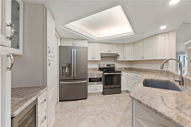 kitchen featuring stainless steel appliances, beverage cooler, white cabinets, and sink