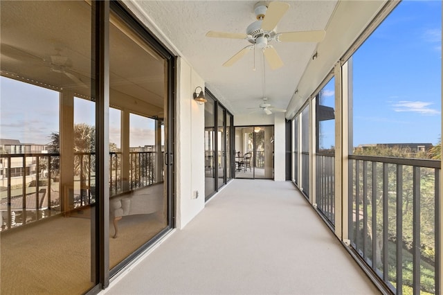 sunroom / solarium featuring ceiling fan