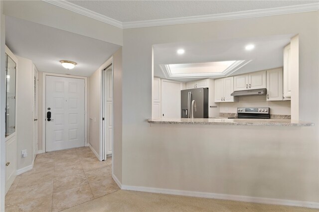 kitchen featuring light tile patterned flooring, appliances with stainless steel finishes, a skylight, crown molding, and white cabinets