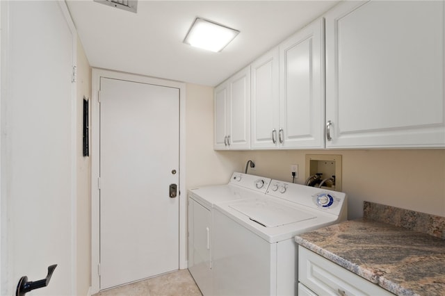 laundry room with separate washer and dryer, cabinets, and light tile patterned flooring