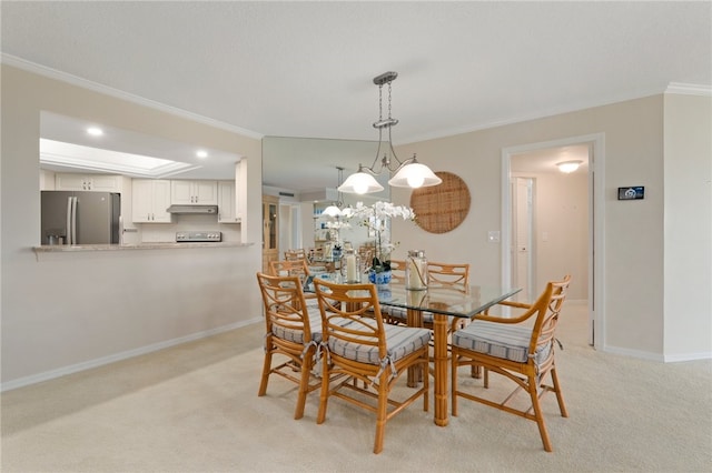 dining room with light colored carpet, a chandelier, and crown molding