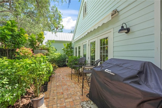 1541 Sabal Ct, Vero Beach, FL 32963 - view of patio with a grill and french doors