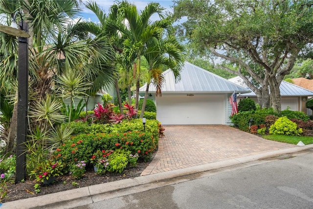 1541 Sabal Ct, Vero Beach, FL 32963 - view of front facade with decorative driveway and metal roof