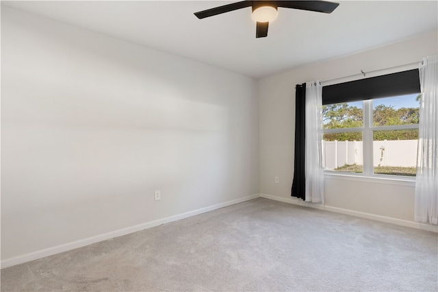 unfurnished room featuring light colored carpet and ceiling fan