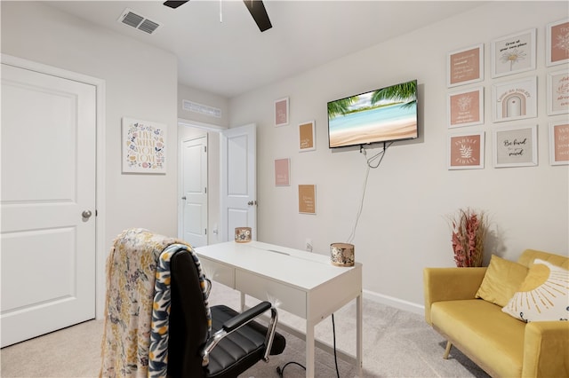 carpeted home office featuring ceiling fan