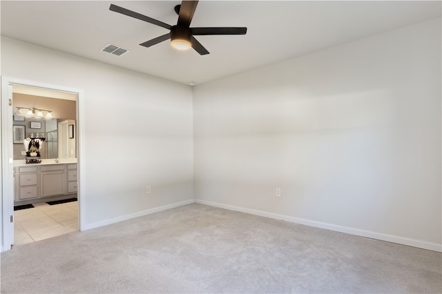 unfurnished room with ceiling fan and light carpet