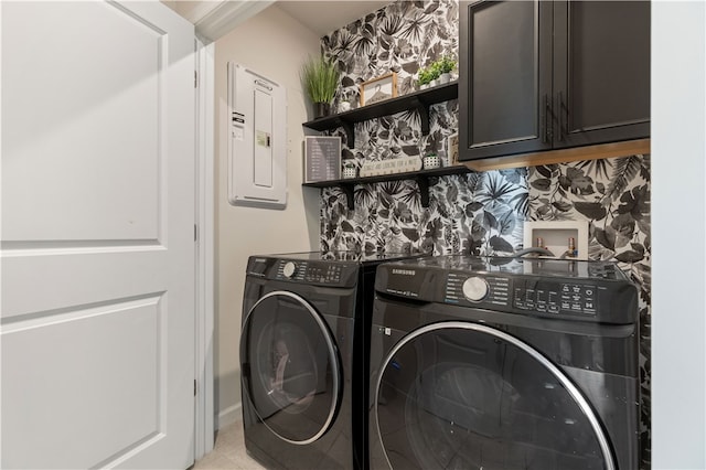 laundry area featuring cabinets, independent washer and dryer, electric panel, and light tile patterned flooring