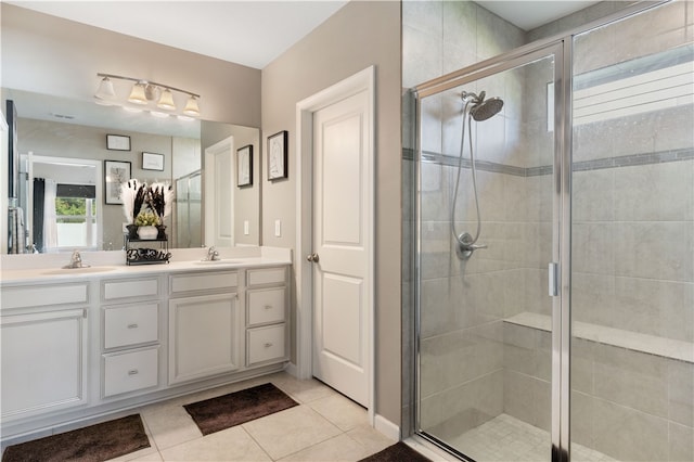 bathroom with tile patterned flooring, vanity, and a shower with shower door