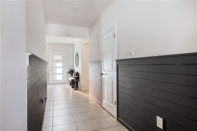 corridor featuring light tile patterned floors