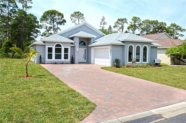 ranch-style home with a garage and a front yard