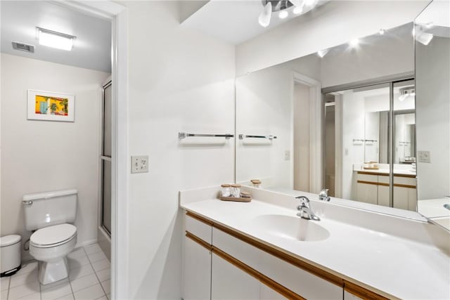 25 Plantation Dr Unit 201, Vero Beach, FL 32966 - full bath featuring toilet, a shower with door, tile patterned floors, and vanity