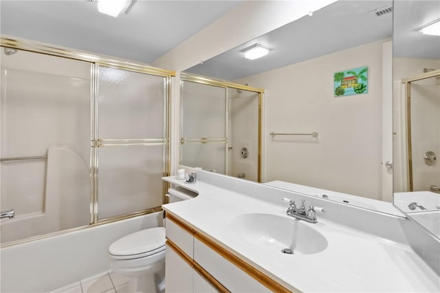 25 Plantation Dr Unit 201, Vero Beach, FL 32966 - bathroom featuring vanity, toilet, tile patterned floors, and combined bath / shower with glass door