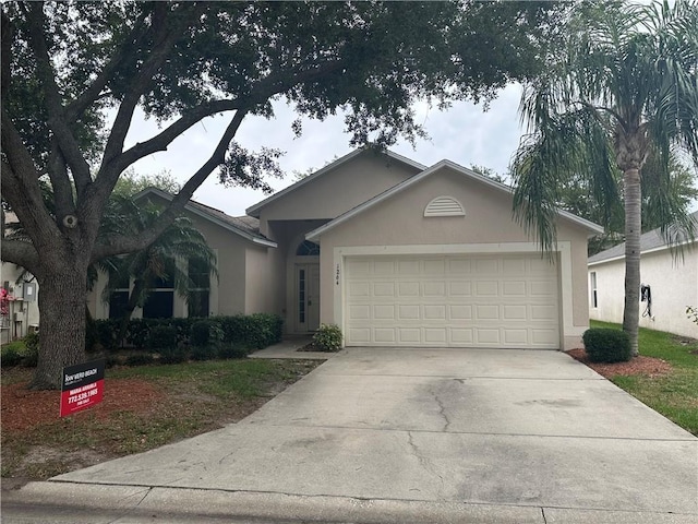 single story home featuring stucco siding, driveway, and an attached garage