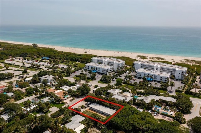 aerial view featuring a view of the beach and a water view