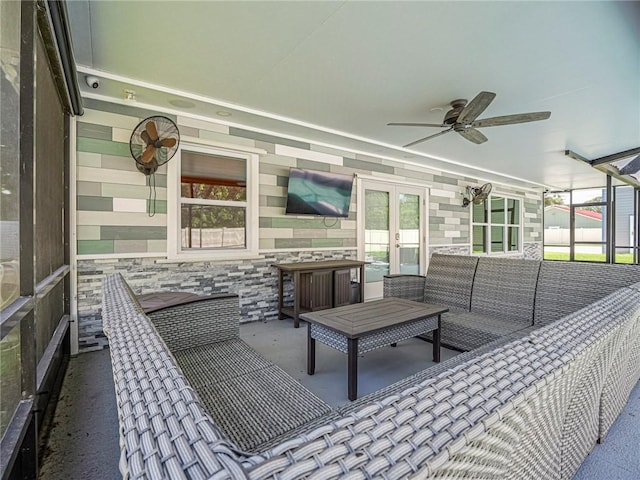 exterior space featuring a lanai, french doors, a ceiling fan, and an outdoor hangout area