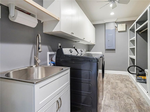 clothes washing area featuring separate washer and dryer, baseboards, electric panel, a ceiling fan, and cabinet space