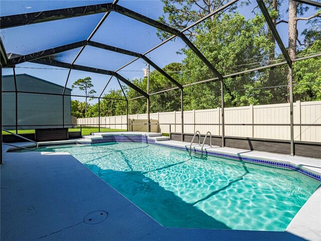 view of swimming pool with a fenced backyard, an outdoor structure, a patio, a storage unit, and a fenced in pool