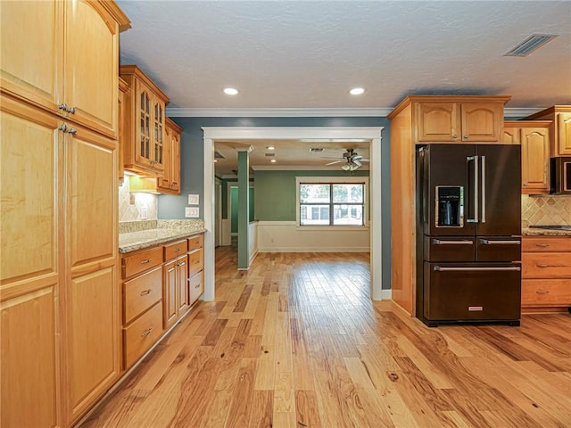 kitchen featuring light wood-style flooring, a ceiling fan, ornamental molding, black appliances, and decorative backsplash