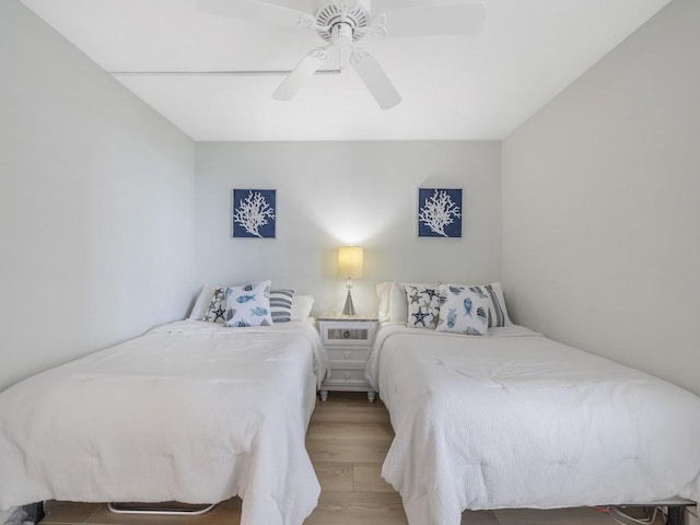 bedroom with a ceiling fan and wood finished floors